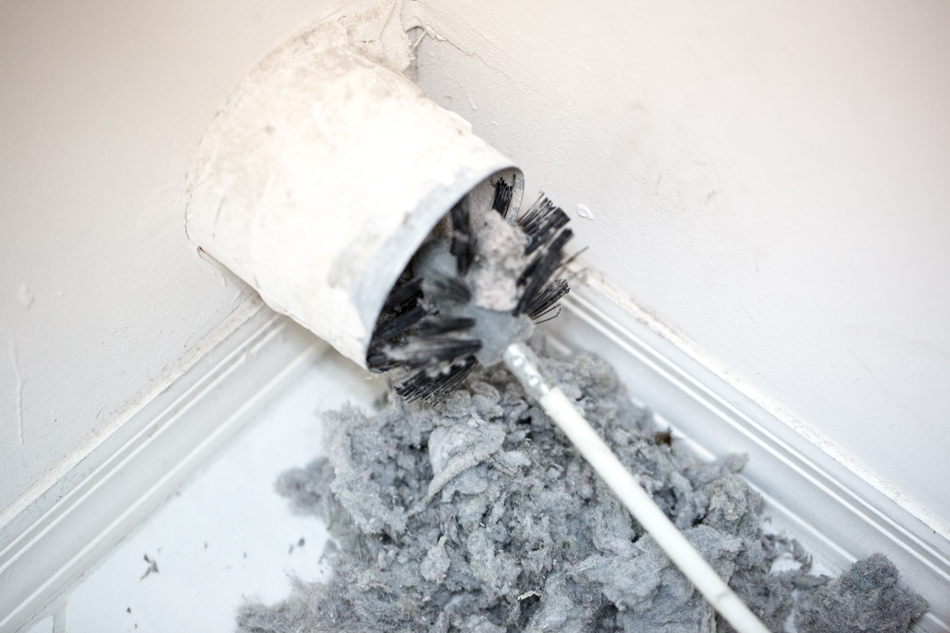 Dryer-vent-in-a-home-being-cleaned-out-with-a-round-brush-497609526 Dryer vent in a home being cleaned out with a round brush